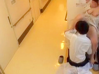 In Japan, a sexually frustrated busty patient visits her doctor for some XXX nippon fun in a clinic hallway.